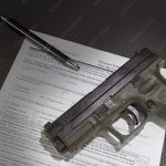 Handgun and the paperwork to get a background check before taking ownership