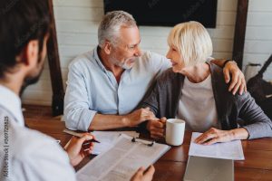 Male realtor make offer for sale to old customers indoors